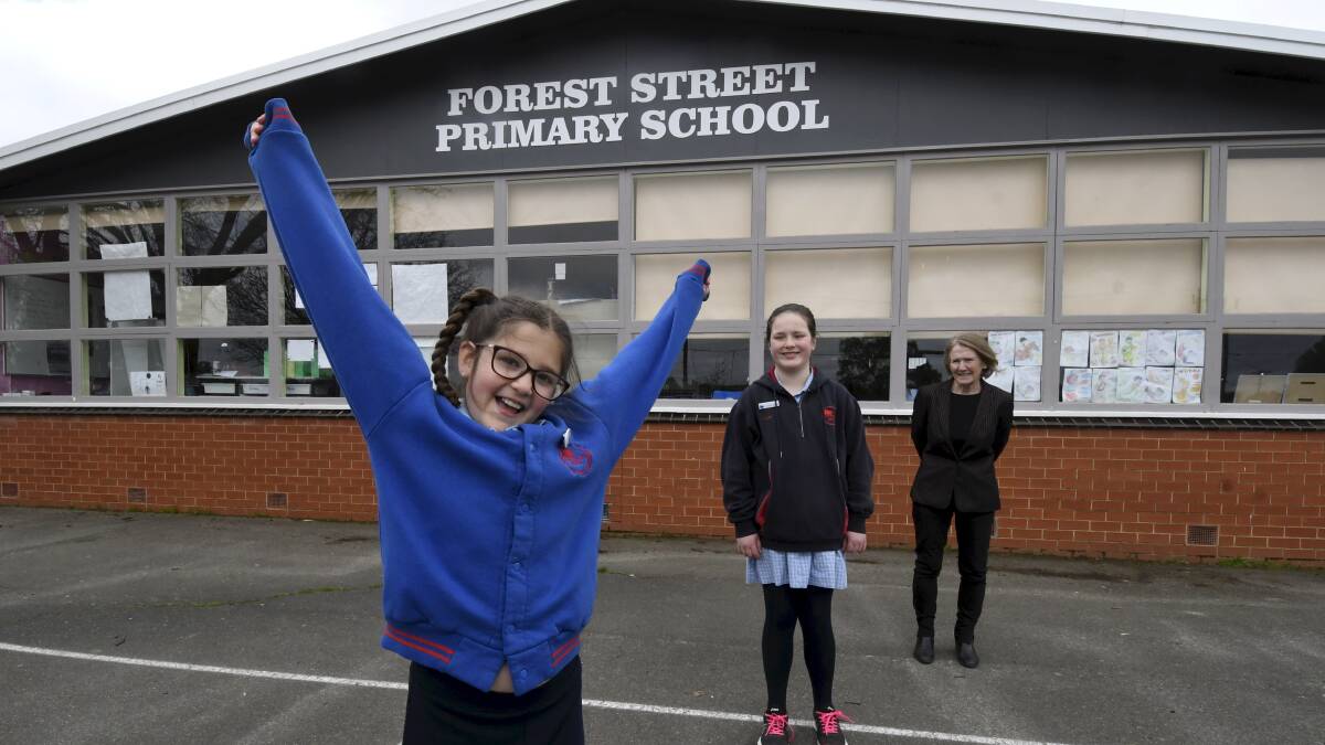 JUMPING FOR JOY: Grade four pupil Jade celebrates an exciting future for the Forest Street Primary with school captain Kate and principal Jill Burt. Picture: Lachlan Bence