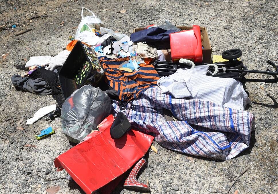 DUMPED: Storage bags, a stroller, toys, clothes, shoes and other junk thoughtlessly discarded in the bush instead of being properly disposed of.