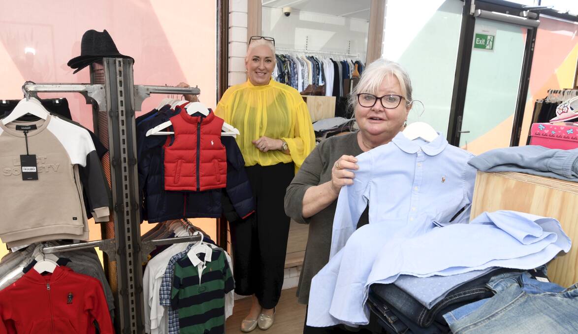 RETAIL: Cafs volunteer and program leader Nicole Roberts and Thread Together volunteer Alison Balfour with some of the clothes people in need can choose. Picture: Lachlan Bence
