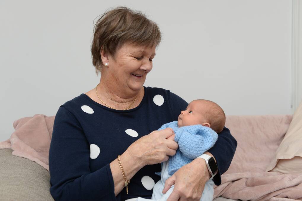 FAMILY: Marie Clark has her first cuddle with her 50th and youngest grandchild Louis who is two weeks old. Picture: Kate Healy