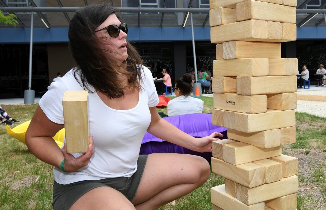 BALANCE: Louise Marenday plays giant Jenga at last year's O-Week activities at Federation University, a week of activities designed to give new students an introduction to the university and university life. Picture: Lachlan Bence