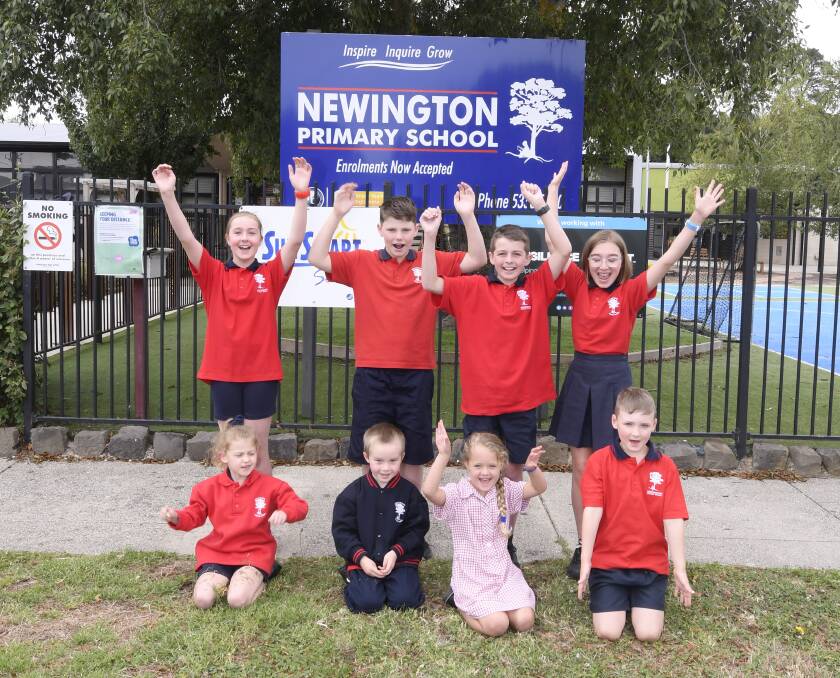 NEW NAME: Newington Primary pupils (back) Savannah, Fraser, Fletcher, Jemima and (front) Taylor, Lucas, Savannah and Frederick with the new school sign after changing over from the former Urquhart Park Primary identity. Picture: Lachlan Bence