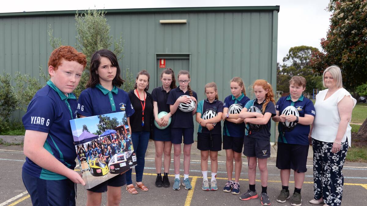 DEVASTATED: Caledonian Primary School's Energy Breakthrough team and principal Brea Terris outside the shed from which their race carts were stolen. Picture: Kate Healy