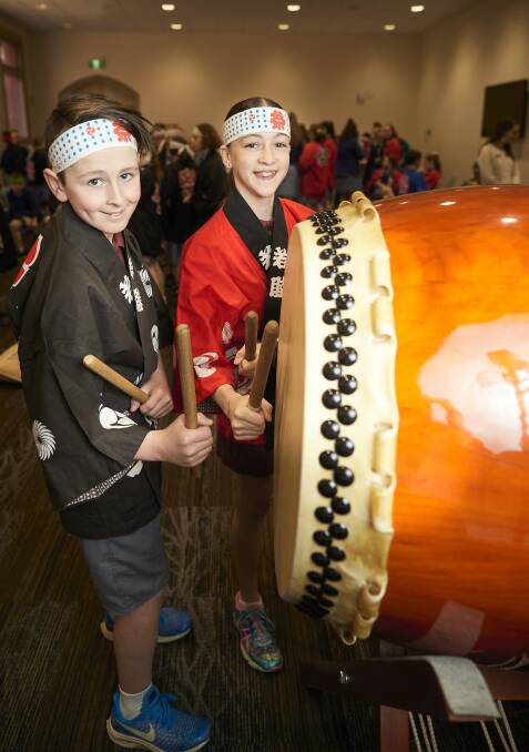 TEMPO: St Alipius’ Primary pupils Thomas and Milly with a traditional Taiko drum, part of a Japanese Karuta Challenge day held among catholic schools. Picture: Luka Kauzlaric