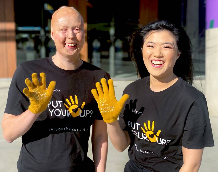 Matt and Annie model the Kids Foundation Put Your Hand Up campaign gloves