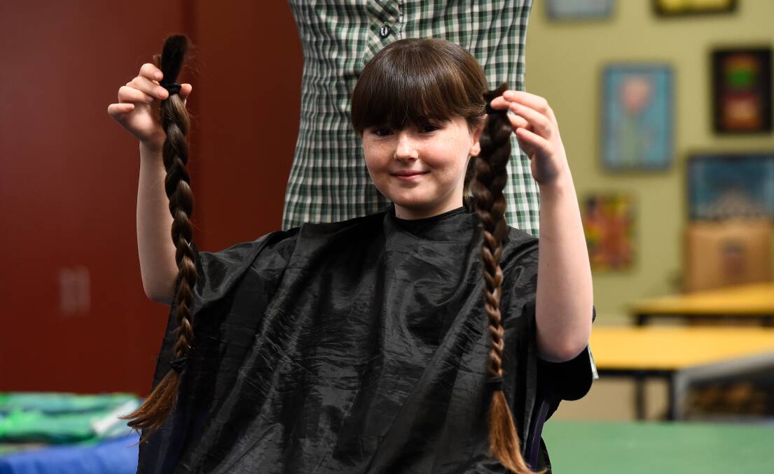 Abbie's plaits are gone ... next come the clippers to shave her head. Picture by Adam Trafford
