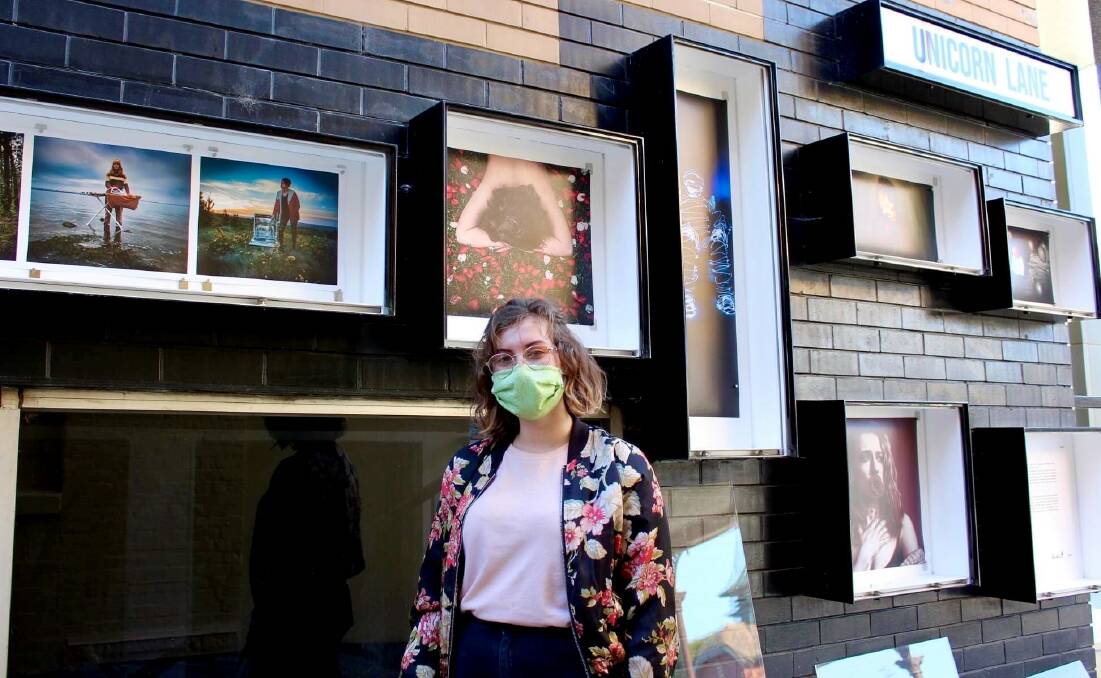 ON SHOW: Damascus College student Charlotte Grimes with her photos on display in Unicorn Lane. Picture: supplied