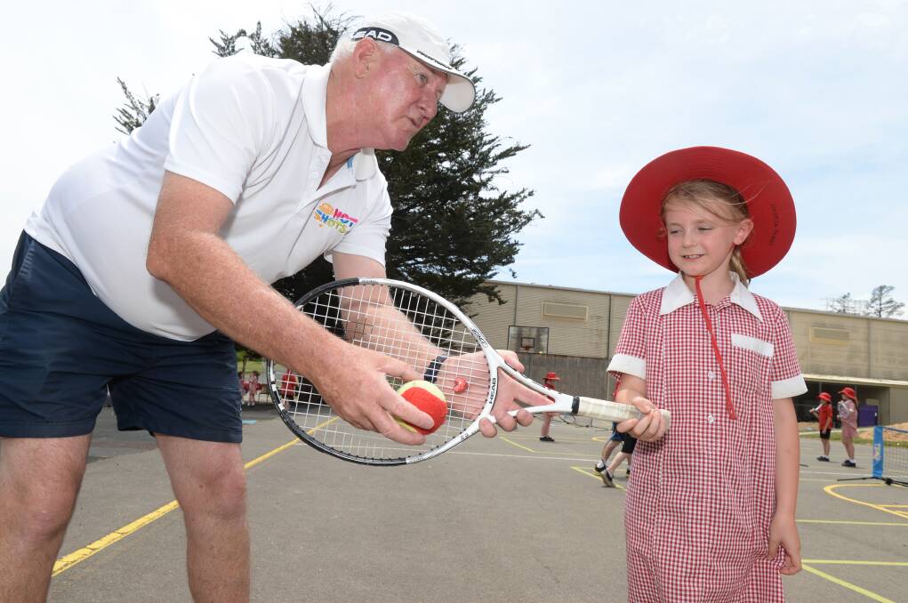 COACH: Zoe Hives' junior coach Peter Joyce introduces tennis to a new generation of students at Buninyong Primary School.