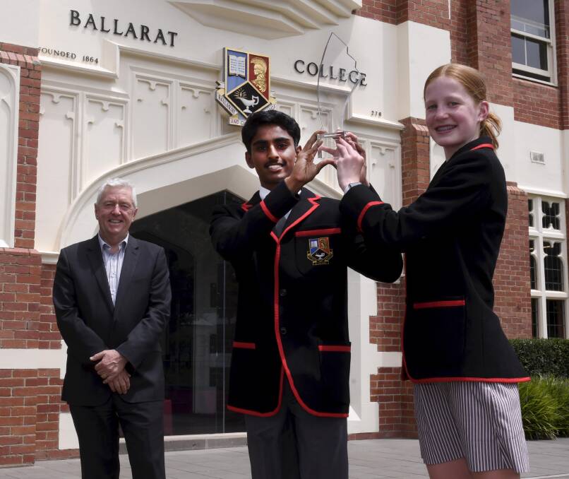 TOP AWARD: Ballarat Clarendon College principal David Shepherd and students Youhanna and Madison with the Australian Education Awards trophy for the best non-government school in the country. Picture: Lachlan Bence