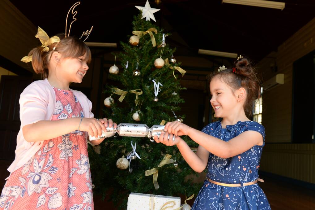 TOGETHER: Making sure everyone has fun and makes friends around the Christmas tree, like Aiyah Hannan, 6 and Charli Douglas, 5, is the goal for their mums who are organising Christmas lunch at Dean Hall. Picture: Kate Healy