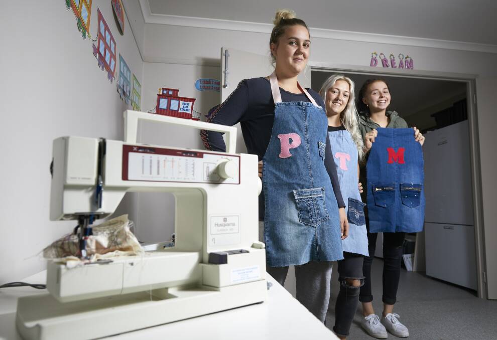 NEW SKILLS: Young Parents Program participants Pippie Lewis, Teagan Fisher and Molly Beaton with their new aprons. Picture: Luka Kauzlaric