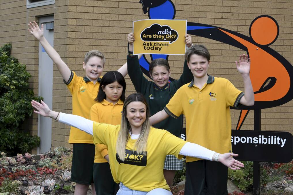 READY: Alfredton Primary School pupils Jed, Danica, Lily, and Fletcher with teacher Gabrielle Mathieson will don yellow for R U OK? Day on Thursday. Picture: Lachlan Bence