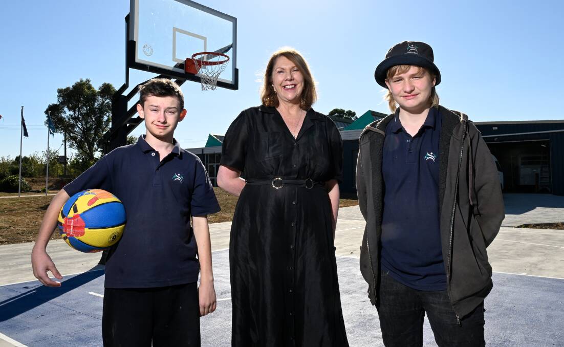 Students Seth (left) and Jayden with Catherine King, Federal Member for Ballarat, on the new basketball court at Yuille Park Community College's Yuille campus on McKenzie Drive. Picture by Adam Trafford