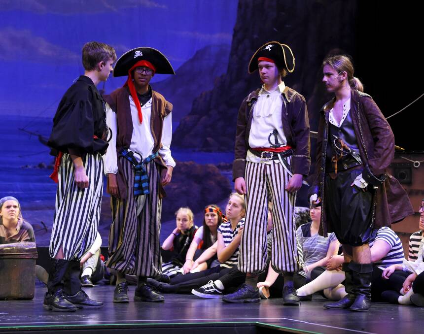 GANG: Four pirates confer on stage as Phoenix College actors polish their performance of Pirates of Penzance.