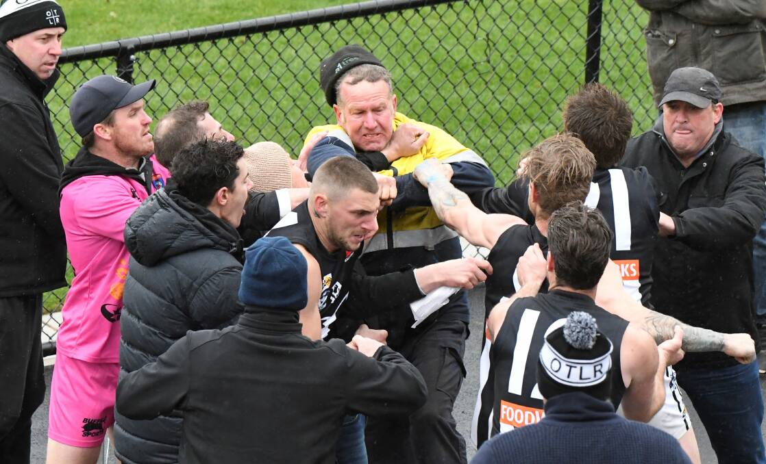 FRACAS: Fists fly during a half-time clash involving a spectator and Darley players during the East Point v Darley preliminary final at City Oval on Saturday. Picture: Lachlan Bence.