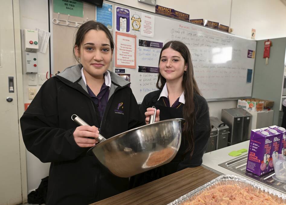 Phoenix P-12 Community College year seven students Zoe and Emily were among 250 students taking part in a community volunteer day which included cooking meals for Soup Bus. Picture by Lachlan Bence