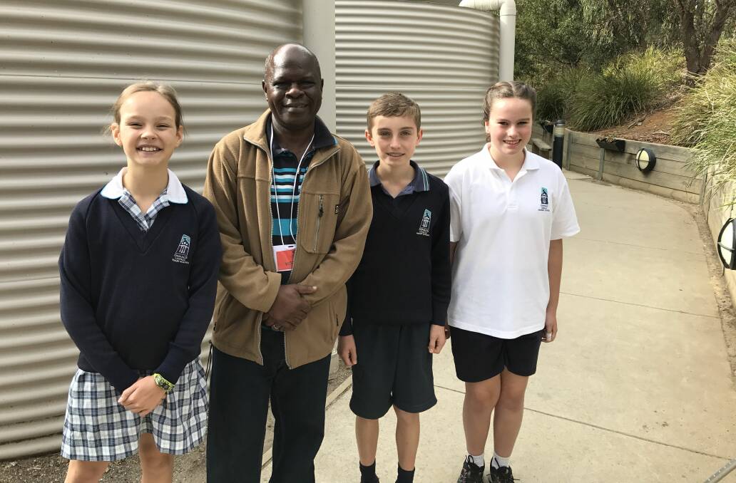 WATER: Emmaus Primary School students Dana, Liam and Bessie with Super Dube from Zimbabwe who spoke to grade five and six pupils about water security as part of Project Compassion. Picture: Michelle Smith