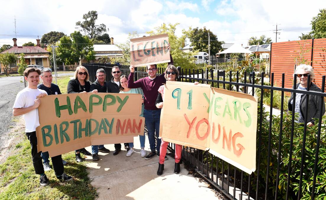 CELEBRATION: Margaret Britt, right, and her family celebrate her 91st birthday with signs and social distancing. Picture: Adam Trafford
