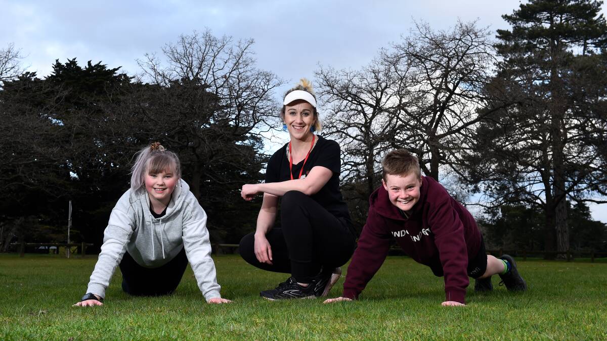 ACTIVE: Melinda Sands with kids Kai and Will at Victoria Park for an Own Your Game kids fitness and fun session. Picture: Adam Trafford