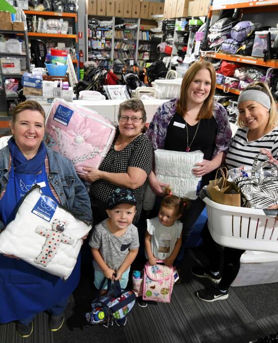 HELPERS: Leanne Fawcett, Margaret Robinson, Felicity Smolenaers, Sarah Greig, 4, Billy Greig, 2, and Phoebe Greig with some of the donated goods to be distributed to mums in need through Eureka Mums. Picture: Lachlan Bence