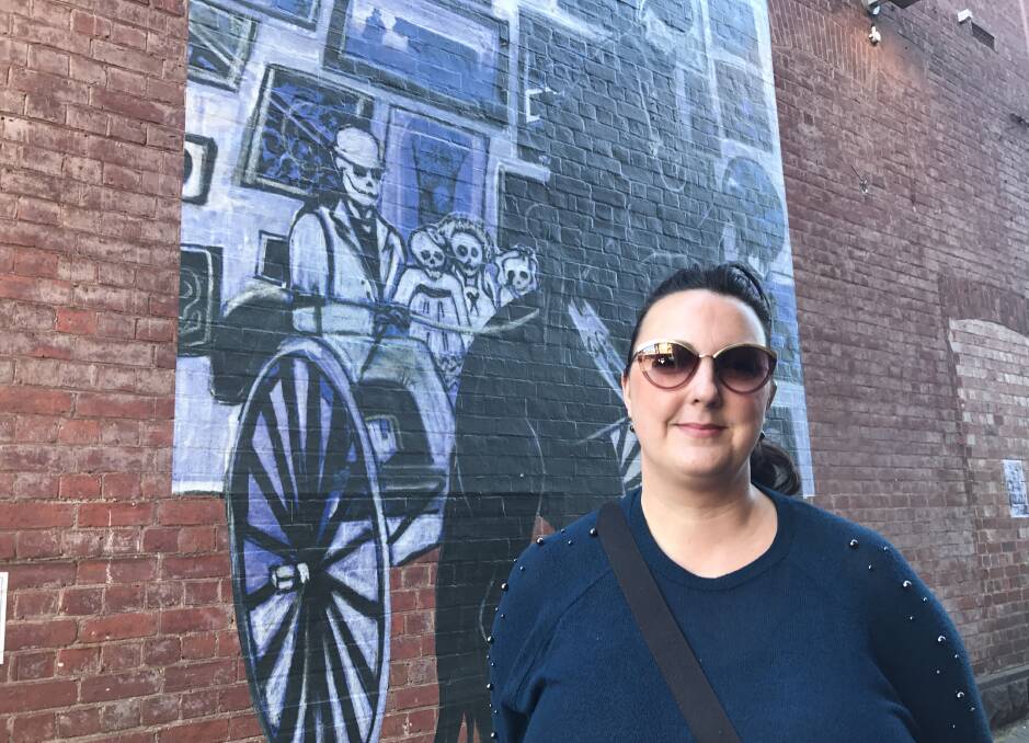 LARGE SCALE: Samantha Thompson with her augmented reality mural Seize the Day in Police Lane. Picture: Michelle Smith