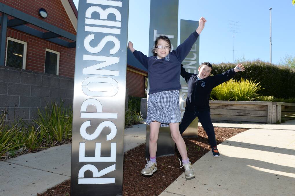 VALUES: Mt Pleasant Primary year four pupils Max and Freya reflect on the school values of responsibility, respect and resilience which stand at the front of the school in 2.4m pillars that are illuminated at night. Picture: Kate Healy
