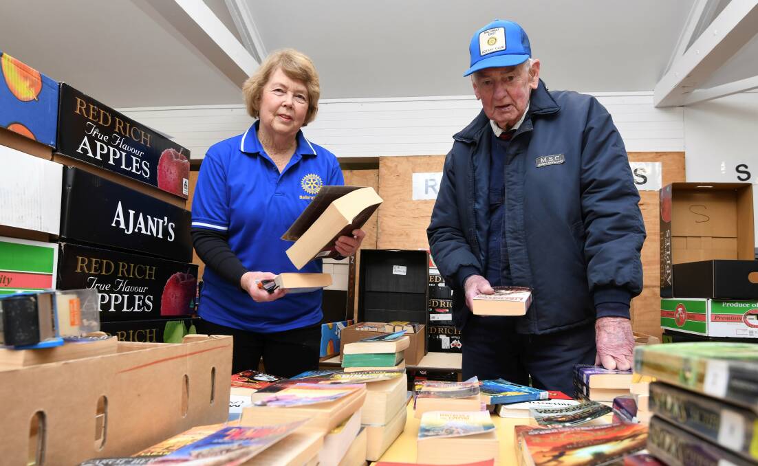 MANY HATS: Bill Llewellyn in one of his other volunteer roles, pictured here with Margaret Robinson as organiser of Ballarat's Biggest Book Bonanza. Picture: Lachlan Bence