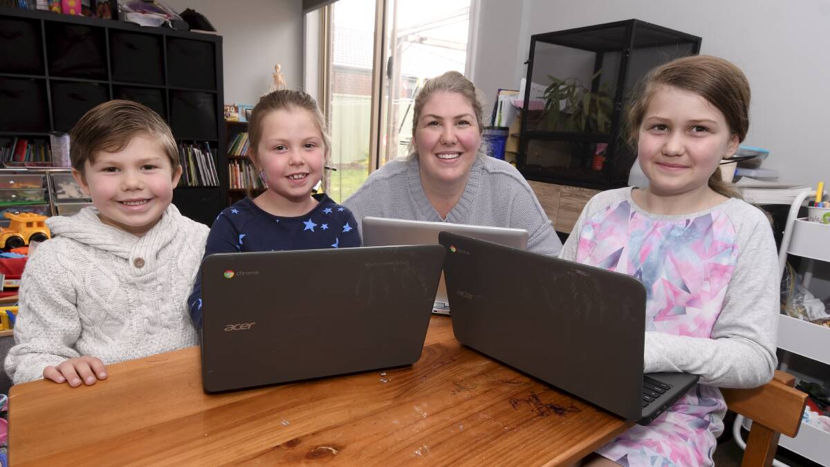 ALL SCHOOLING: Micah, 5, Ella, 7, Addison, 9, and mum Brooke Croton are all remote learning at home, juggling family life with a baby and full time study. Picture: Lachlan Bence