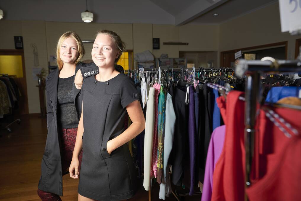 DESIGNER: Sarah Bendixen  and Jessica Post model some of the fashion finds from among the racks of designer clothing at St Matthew's Op Shop in Wendouree. Picture: Luka Kauzlaric