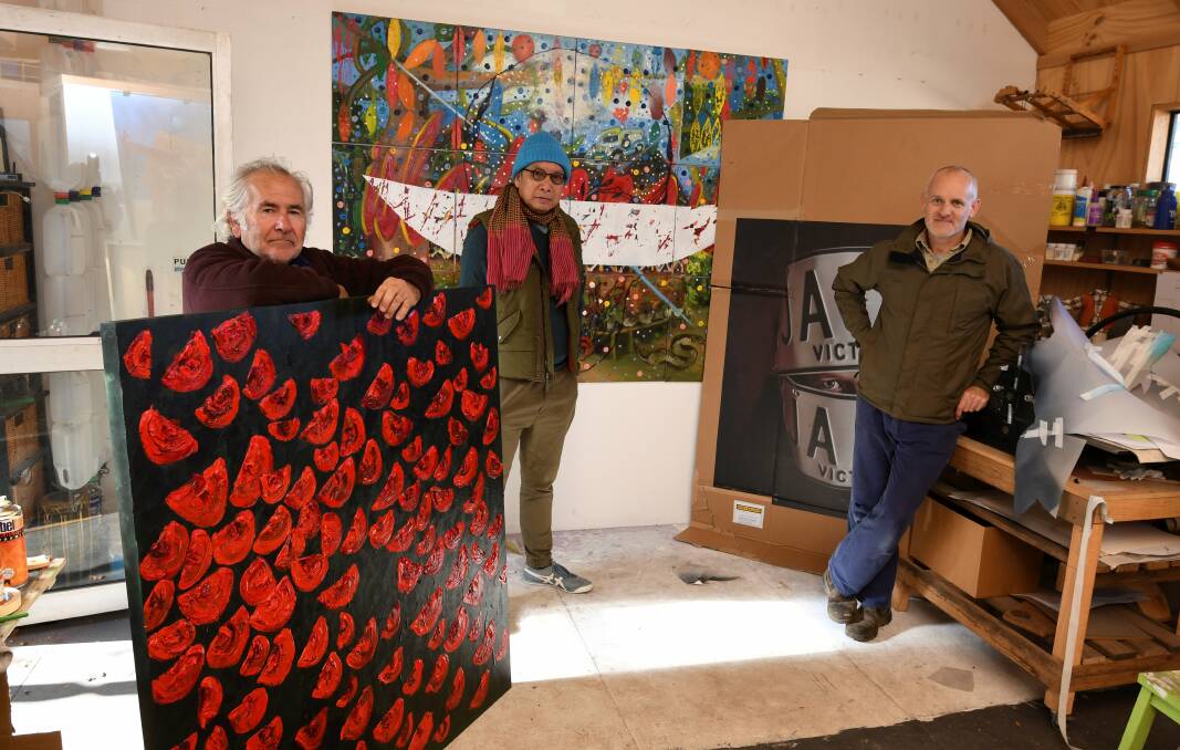 LARGE SCALE: Artists PJ Gregg, Diokno Pasilan and Scott Fredericks show their art that will be exhibited in Mixed Blessings. Picture: Lachlan Bence