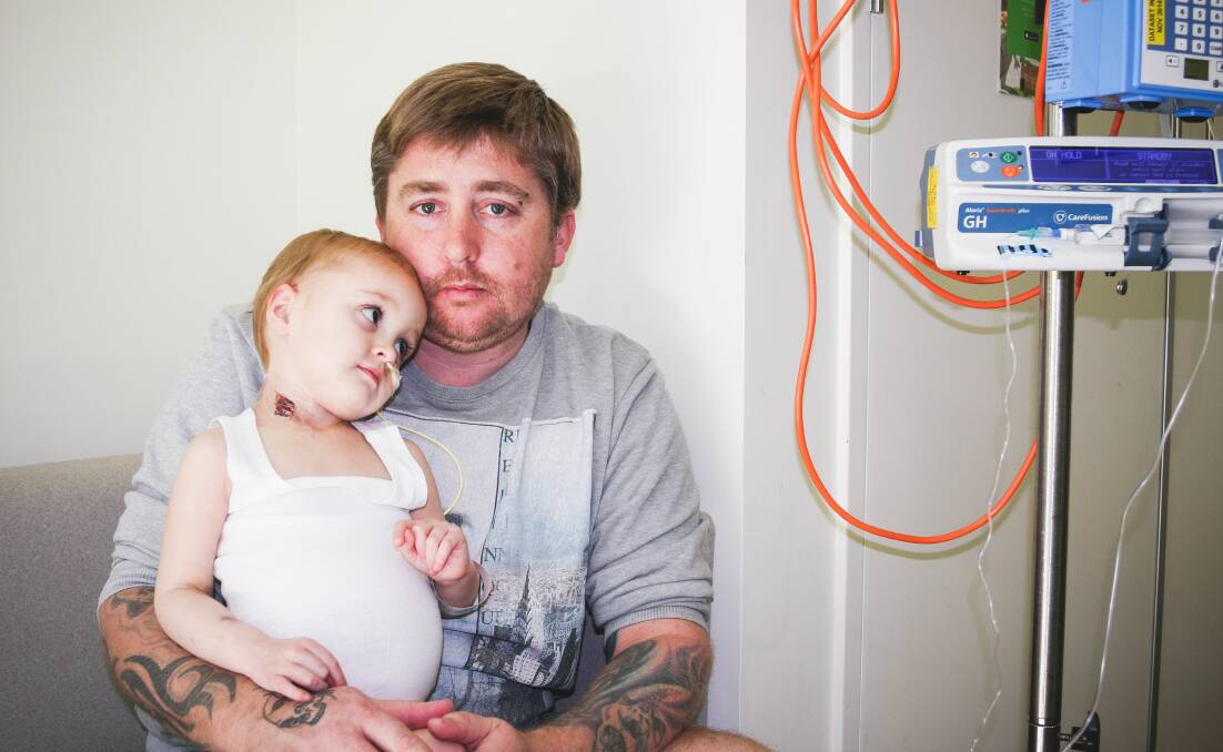 Brenton Butterworth cuddles daughter Mackenzie at the Royal Children's Hospital. Picture: Trish Fort.
