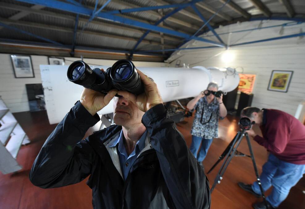 STARRY EYED: Laurence Burk, Kath Blackwell and Trevor Kay get in some practice before the Stargazing Live world record attempt at Ballarat Municipal Observatory on May 23. Picture: Lachlan Bence