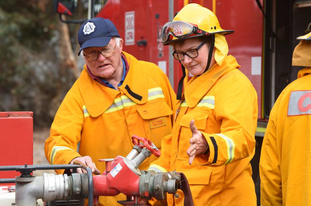HOSES: Stu Thomas from Cape Clear CFA and Wendy Dare from Wendouree CFA work together during a training day for female volunteers at Cape Clear, which attracted about 75 women from across the state. Picture: Kate Healy