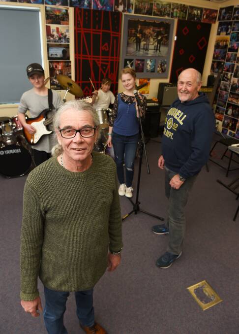 ROCKING OUT: Ballarat Specialist School music teachers Roly Weatherall and Russell White with young musicians Alex, 15, Andy, 14, and Rachael, 17. Picture: Lachlan Bence