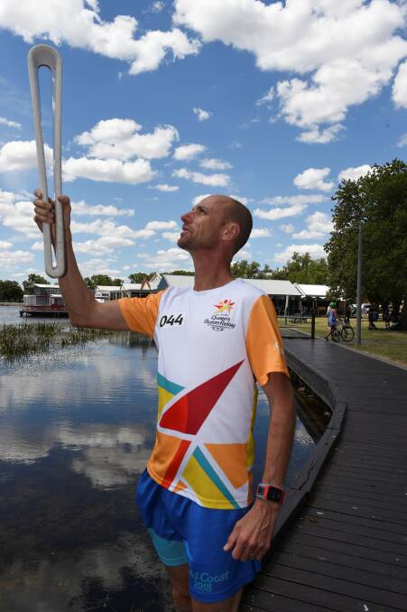 REPEAT: Steve Moneghetti with the Queen's Baton in 2018 as it made its way around Australia before the Gold Coast hosted the Commonwealth Games. Picture: Lachlan Bence 