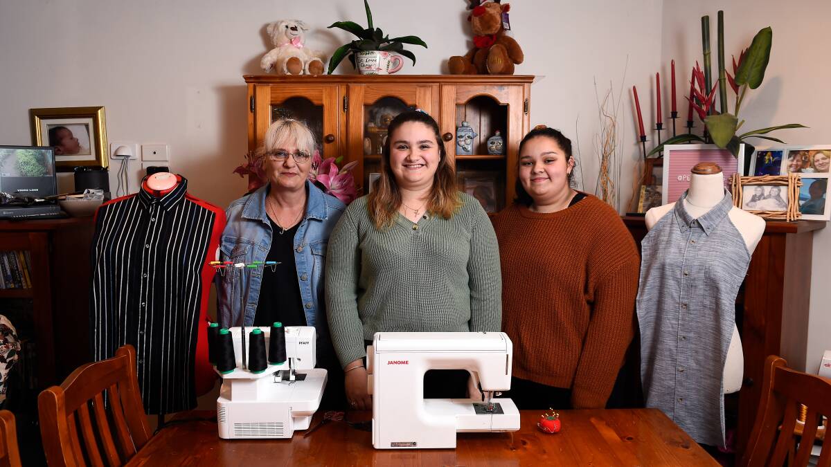 PROJECT: Paige Meyer's mother Jodi and sister Jordyn are helping her sew dignity bibs to donate to aged care homes and special schools. Picture: Adam Trafford