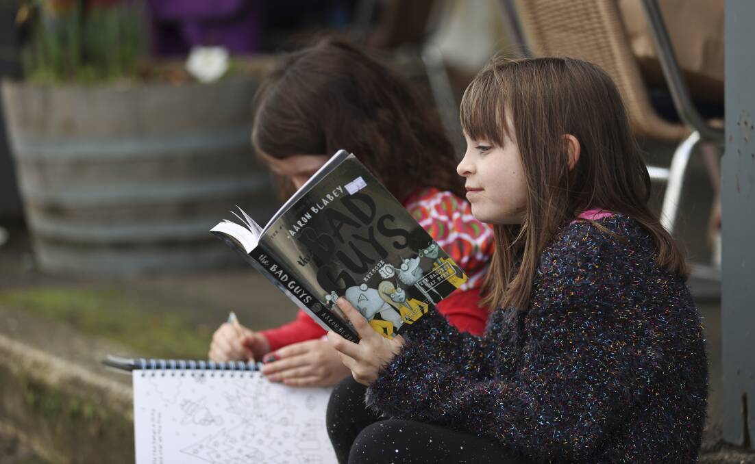 BOOKWORM: Aria McNamara reads during the Clunes Booktown Festival. Picture: Luke Hemer