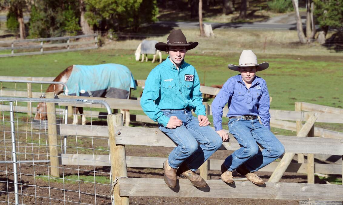 RELAX: Clay Donald, 13, and Spencer Donald, 11 take a break with their horse Rango before the family heads off to Emerald, Queensland, so the boys can compete in the national rodeo titles. Picture: Kate Healy