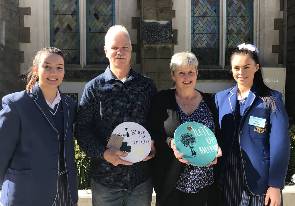 PLATE ART: Lynette and Andres Haas from Black Cat Truffles receive their decorated plates, as participants in the Plate Up Ballarat festival, from Loreto students Maddy Reyntjes and River Ferguson. Picture: Michelle Smith