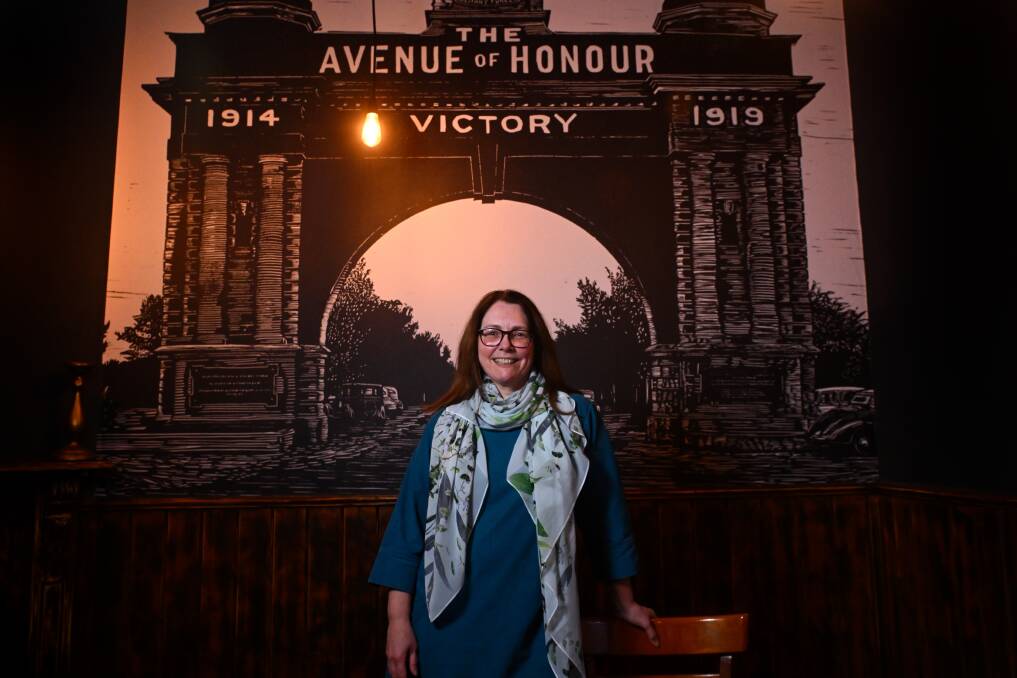 Linocut print maker Amanda Western with her Arch of Victory mural installed on a wall at the Mallow Hotel. Ms Western received a BAF grant to buy a large drying rack for her specialised prints. 