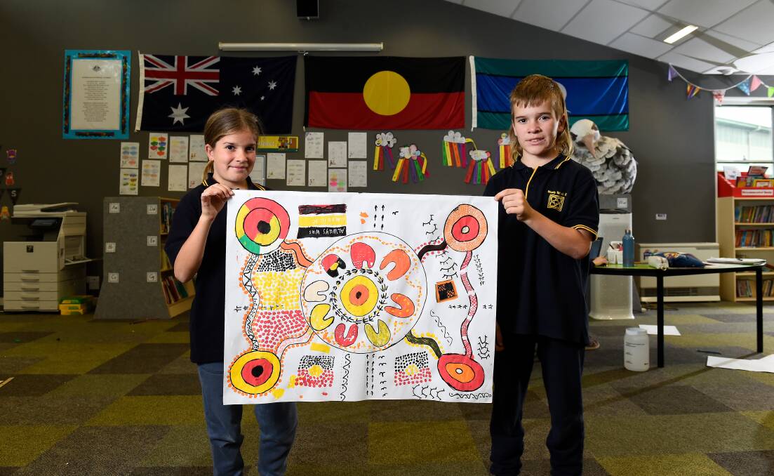 ART: Woady Yaloak Primary School Koorie Club members Indy and Jordan with some of the artwork to be featured in the school's redevelopment. Picture: Adam Trafford