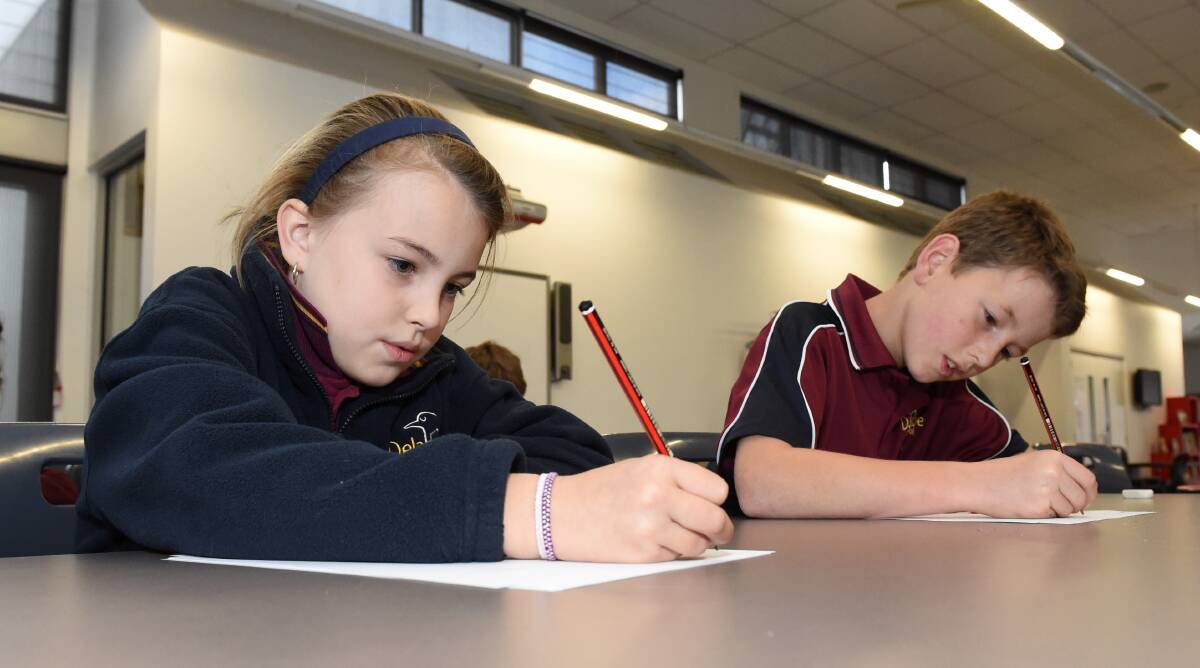Testing time: Delacombe Primary School pupils Lilah, grade three, and Max, grade five, sit their language conventions and writing NAPLAN tests.