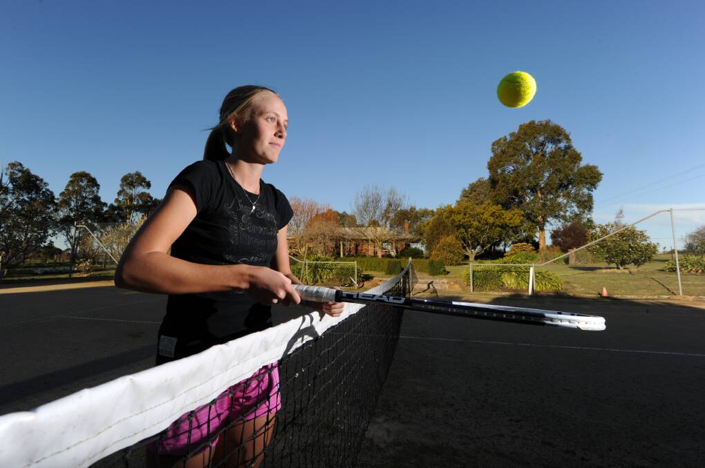 BACK TO THE FUTURE: Zoe Hives when she was 14, pictured on the granite tennis court where it all began on her family's cattle farm at Kingston. Next week she will walk on to the courts of Melbourne Park for her debut in the singles draw of the Australian Open.