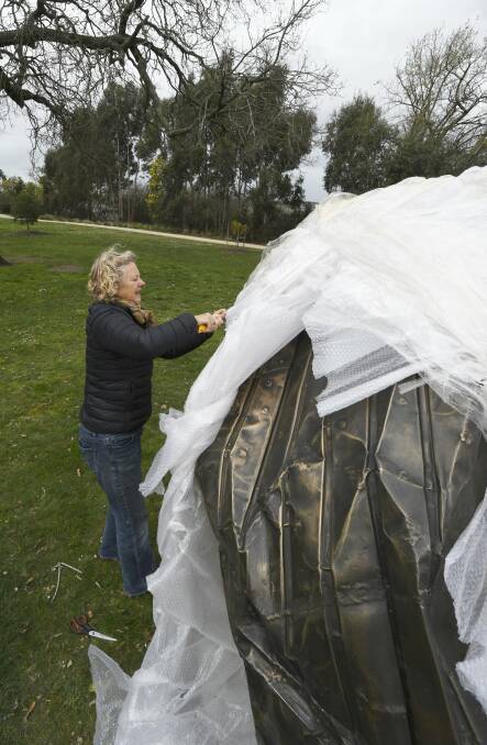UNWRAPPED: Biennale of Australian Art worker Deb Sleeman cuts the bubble wrapping from a sculpture by NSW artist Peter Lundberg, one of 36 sculptures being installed around  Lake Wendouree. Picture: Lachlan Bence