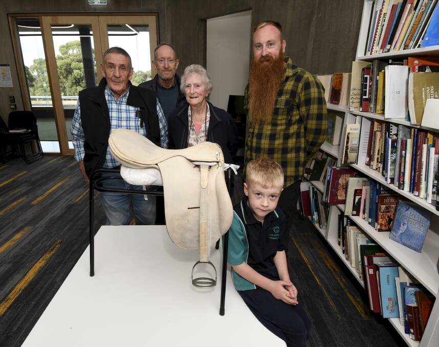 Neville Purdue, Greg Sizeland, Lorna Sizeland, Luke Sizeland and Ned Sizeland, 5, represent four generations of descendants of Ballarat master saddle maker TW Purdue with one of his original saddles which is now in the Sovereign Hill collection. Picture by Lachlan Bence