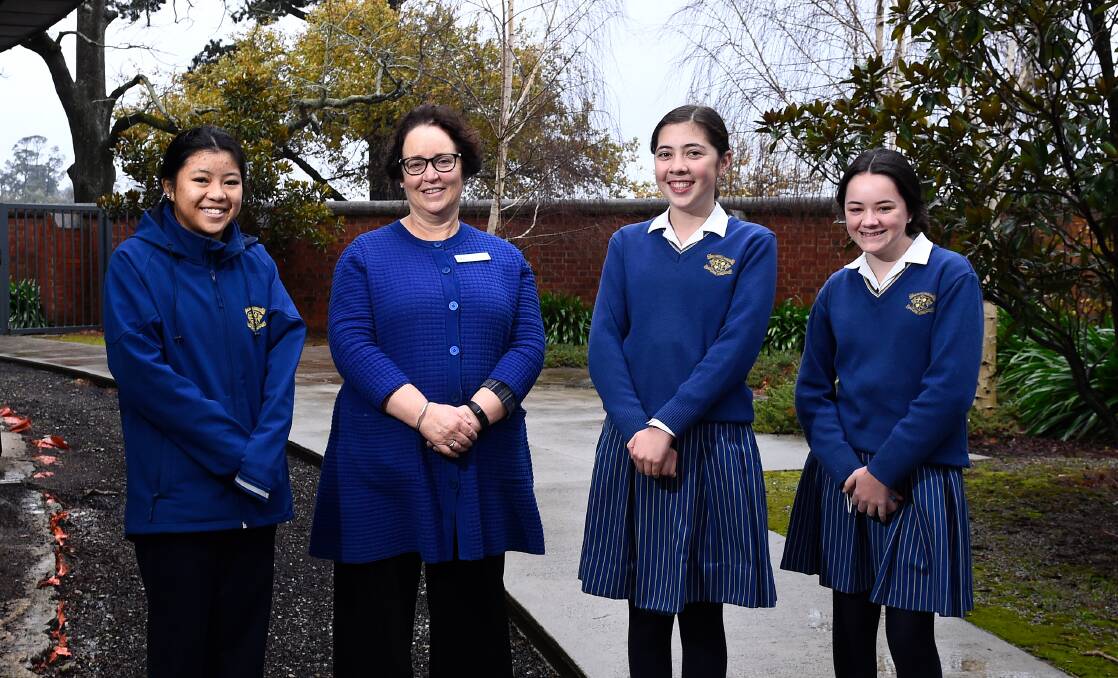 APPEAL: Loreto College learning diversity leader Jillian Hogbin with students Sarah, Skyla and Ayla in the garden. Picture: Adam Trafford