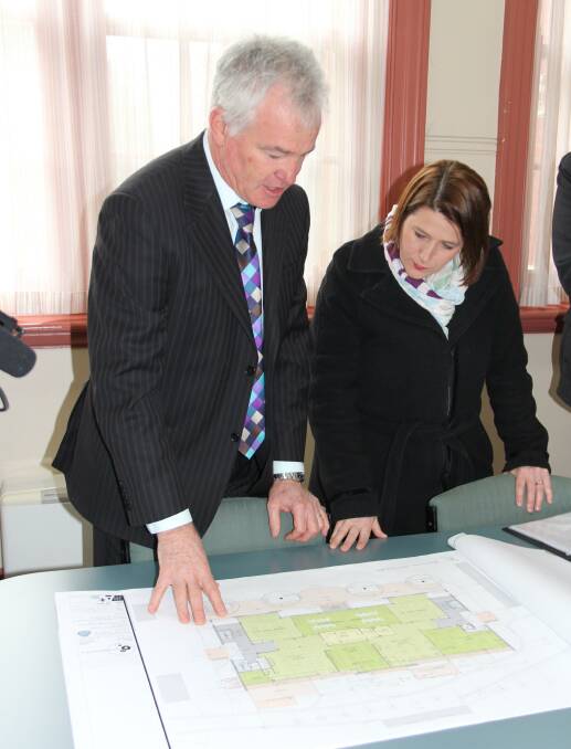 PLANS: Ballarat High School principal Gary Palmer and Wendouree MP Juliana Addison inspect plans for future building projects at the school. Picture: supplied