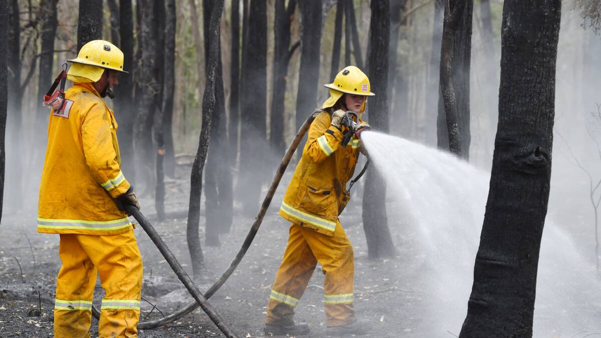 MOP UP: CFA crews extinguish potential hotspots in the aftermath of the Scotsburn fire. Picture: Kate Healy