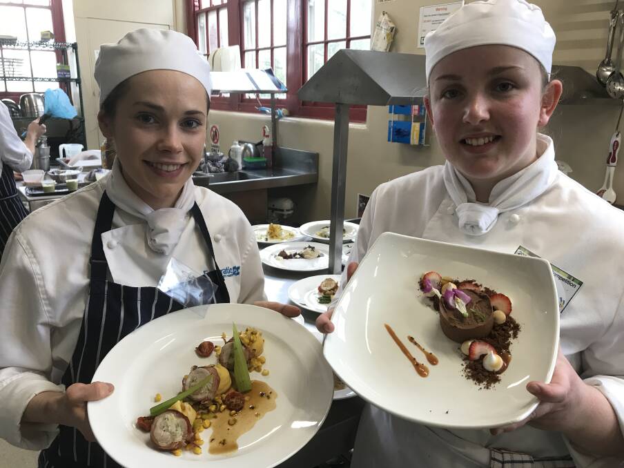 DONE: Casidy Allen and Chloe Flavel with two of the six plates they served up to judges in the WorldSkills Regional Cookery Competition at Fed Uni. Picture: Michelle Smith