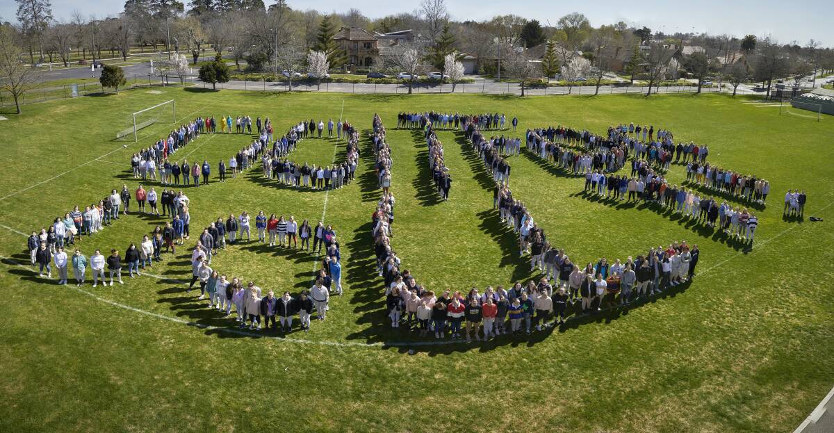 GIRL POWER: Loreto students spell out the Dolly's Dream Foundation logo on a day dedicated to raising funds for the anti-bullying organisation. Picture: Luka Kauzlaric